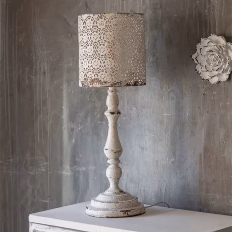 Shops and homes decorate tabletops and walls using antique white metal candlesticks